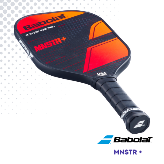 Handle view of the Babolat MNSTR+ paddle, showing the face with orange, red and black graphics against a white background.